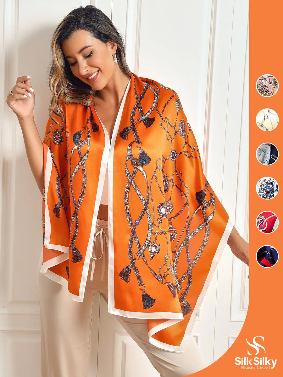 Orange mulberry silk long shawl scarf with chain and tassel print, styled on a woman.