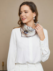 Woman wearing a white mulberry silk printed square scarf with a nautical design.