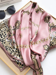 Pink mulberry silk square scarf with gold chain and leopard print.
