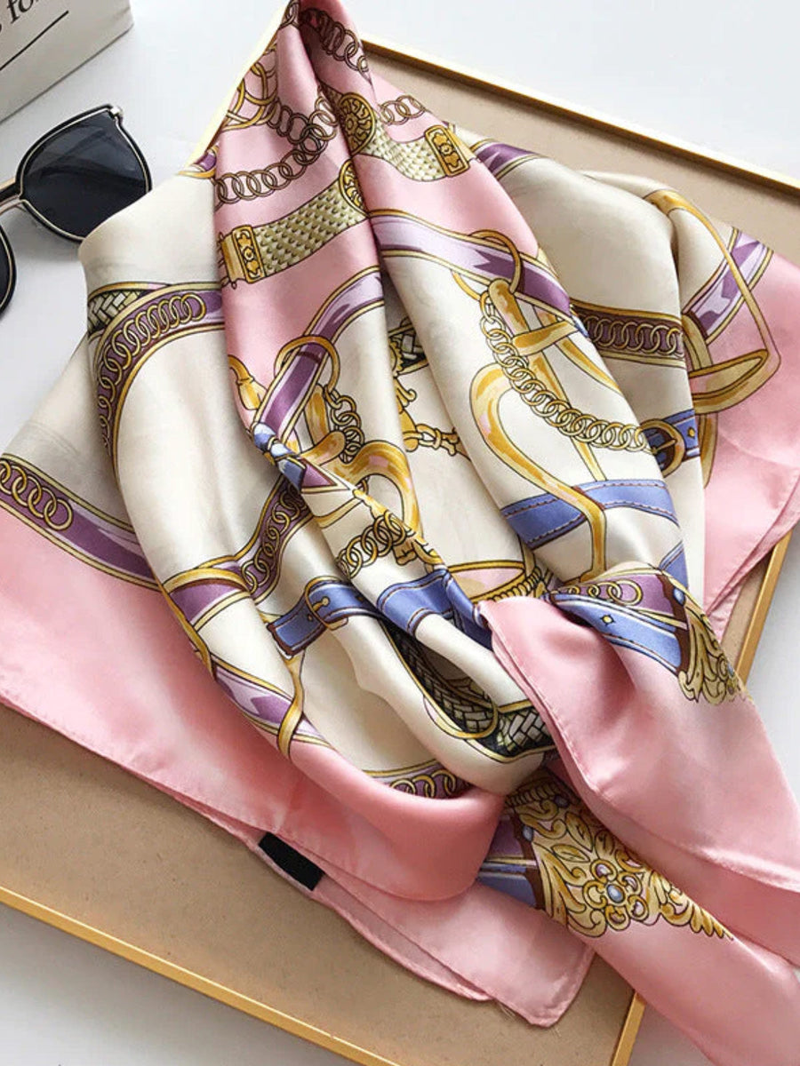 Mulberry silk printed square scarf in pink and cream with gold chain and belt pattern.