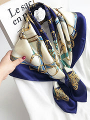 Navy blue and cream 100% mulberry silk square scarf with a gold chain and buckle print.