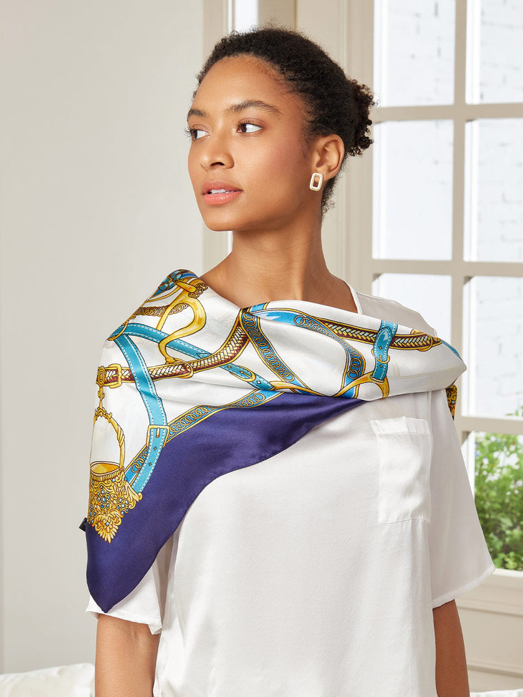 Woman wearing a white 100% Mulberry Silk Printed Square Shawl Scarf with blue and gold chain pattern.