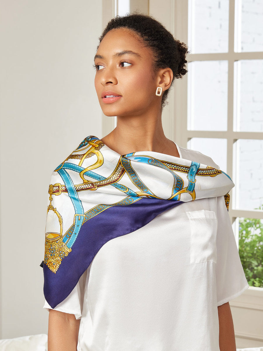 Woman wearing a white 100% Mulberry Silk Printed Square Shawl Scarf with blue and gold chain pattern.