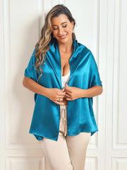 Woman wearing a vibrant teal 100% mulberry silk rectangle long scarf/shawl, 170x53cm, over a white top.