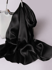 Black 100% Mulberry silk rectangle long scarf/shawl draped over a white handbag.