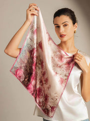 Mulberry silk scarf with a pink rose pattern, held by a woman.