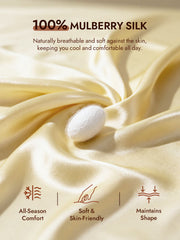 Creamy yellow mulberry silk fabric with a white silkworm cocoon, highlighting soft, skin-friendly comfort.