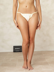 Light yellow mulberry silk ruffle trim string panty on a woman.