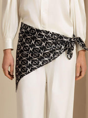 Black and white patterned mulberry silk square scarf tied around a waist.