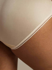 Nude mulberry silk seamless panty with ultra-smooth mesh edge detail, shown on a model.