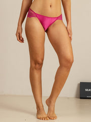 Mulberry silk panty in hot pink with scalloped lace trim, worn by a woman.