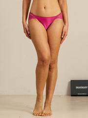 Mulberry silk panty in vibrant pink with scalloped lace trim, worn by a woman.