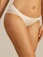 White mulberry silk panty with scalloped lace trim on a woman.