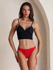 Red 100% Mulberry silk sexy thong panty with lace trim, modeled by a woman.