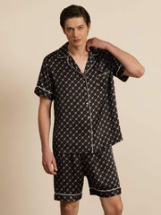 Men's black mulberry silk short sleeve pajamas with chain print and white piping.