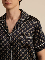 Men's black mulberry silk short sleeve pajamas with white piping and chain print.