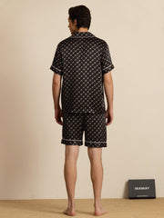 Men's black mulberry silk short sleeve pajamas with chain print and white piping, shown from the back.