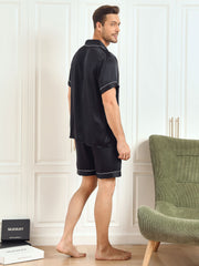 Men's black mulberry silk short sleeve notch collar pajama set with shorts and white piping.