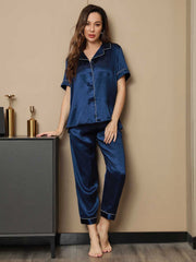 Women's navy blue mulberry silk short sleeve pajamas set with white piping.