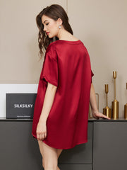 Woman in a luxurious red 100% mulberry silk short sleeve round neck sleep tee.