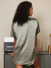Woman in a sage green mulberry silk short sleeve round neck sleep tee.