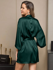 Woman in a dark green mulberry silk short kimono robe with a wrap design.