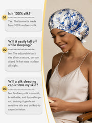 White mulberry silk sleep bonnet with blue floral pattern and ribbons on a smiling woman.