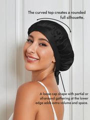 Black mulberry silk sleep bonnet with ribbons, featuring a curved top and gathered edge.