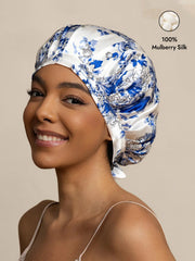 Woman wearing a blue and white porcelain pattern mulberry silk sleep bonnet with ribbons.