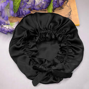 Black mulberry silk sleep cap with a ribbon tie.