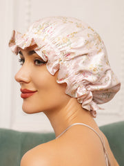 Women's pink floral mulberry silk sleep cap with ruffled edge.