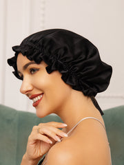 Black mulberry silk sleep cap with ruffled edge and ribbon tie on a woman.
