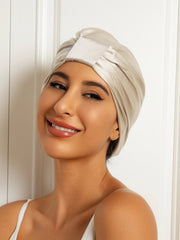 Smiling woman wearing a champagne double-layer mulberry silk sleep cap or night turban bonnet.