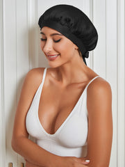 Black mulberry silk sleep cap on a woman, designed for hair protection and anti-frizz.