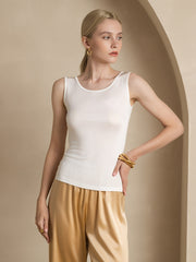 Women's ivory mulberry silk sleeveless tank top with a round neck, paired with gold satin pants.