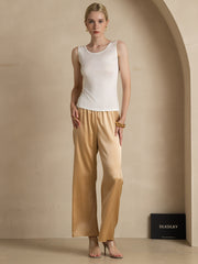 White mulberry silk sleeveless round neck women's tank top with gold silk wide-leg pants.