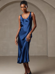 Woman in a luxurious navy blue mulberry silk U-neck sleeveless midi dress.