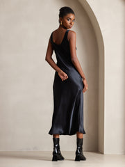 Black mulberry silk sleeveless U-neck midi dress on a model.