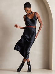 Black 100% Mulberry silk sleeveless U-neck midi dress with a red belt and black boots.