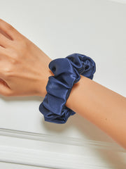 Dark blue 100% Mulberry silk soft large hair scrunchie on a wrist, 3.5cm wide.
