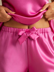 Pink mulberry silk camisole and shorts set with a bow detail.