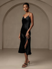 Black mulberry silk cowl neck midi dress with spaghetti straps and split design.