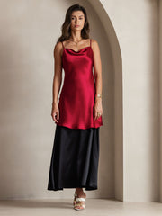 Red mulberry silk spaghetti strap cowl neck short dress worn over a black skirt.