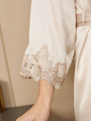 Champagne mulberry silk robe with delicate lace trim on the sleeve, highlighting luxurious women's sleepwear.