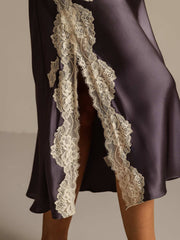 Mulberry silk nightgown in deep purple with a high lace-trimmed split, revealing a leg.