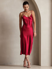 Red mulberry silk spaghetti strap midi dress with a V-neck, worn by a woman with jewelry.