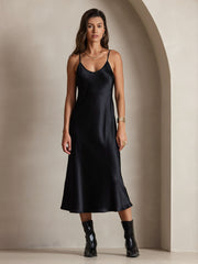 Black mulberry silk spaghetti strap midi dress on a woman.
