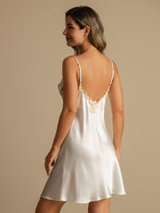 White mulberry silk spaghetti strap nightgown with lace V-back design on a woman.