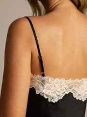Black mulberry silk camisole with spaghetti strap and white lace trim, seen from the back.