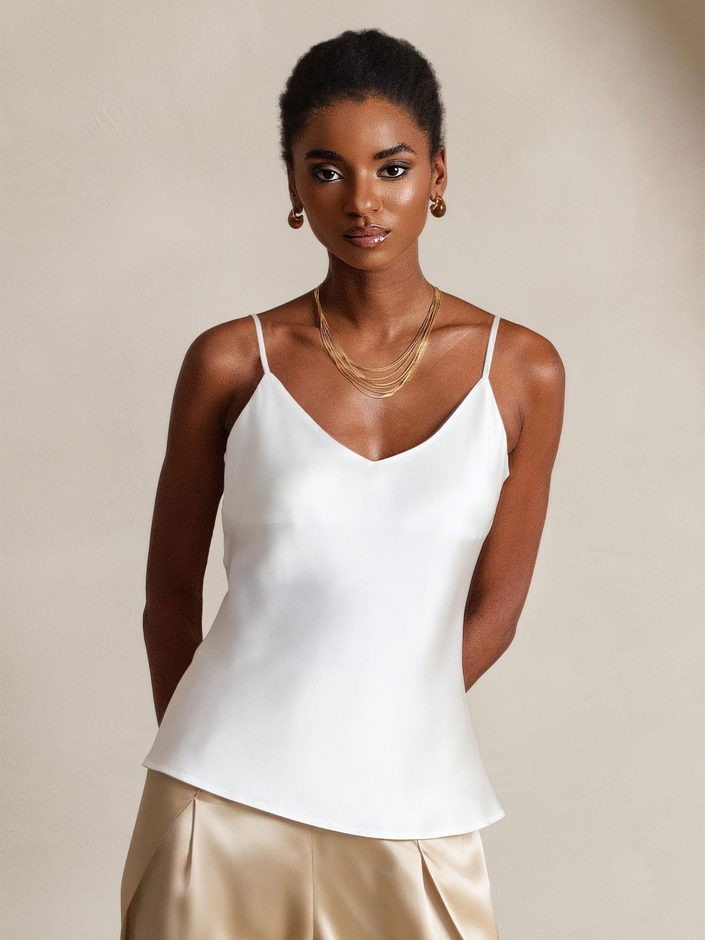 White mulberry silk spaghetti strap V-neck camisole top on a model.